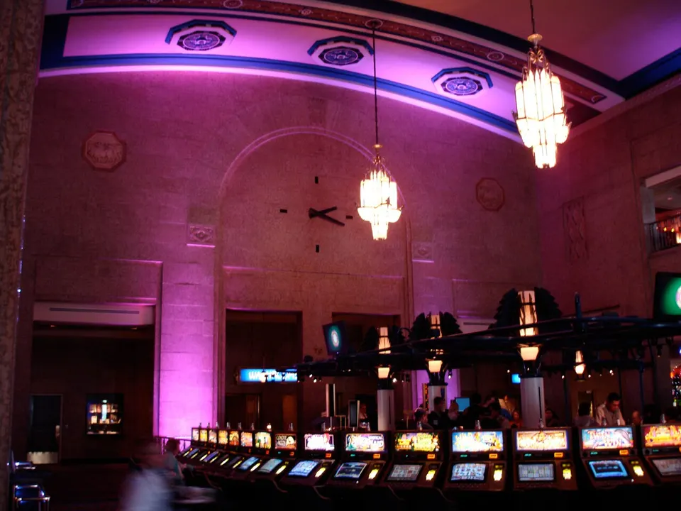 The former Union Station concourse inside Casino Regina, with chandeliers and a large wall clock above rows of slot machines, in 2008