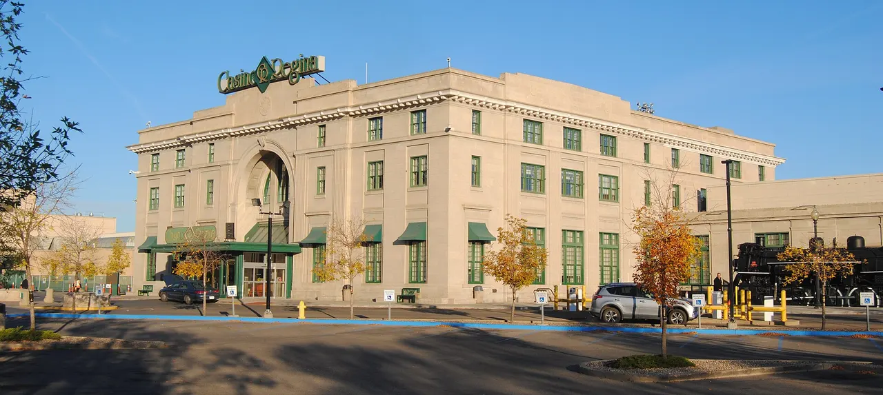 Casino Regina in the former Union Station: a pale stone building with an arched entrance and green awnings, on a sunny autumn day